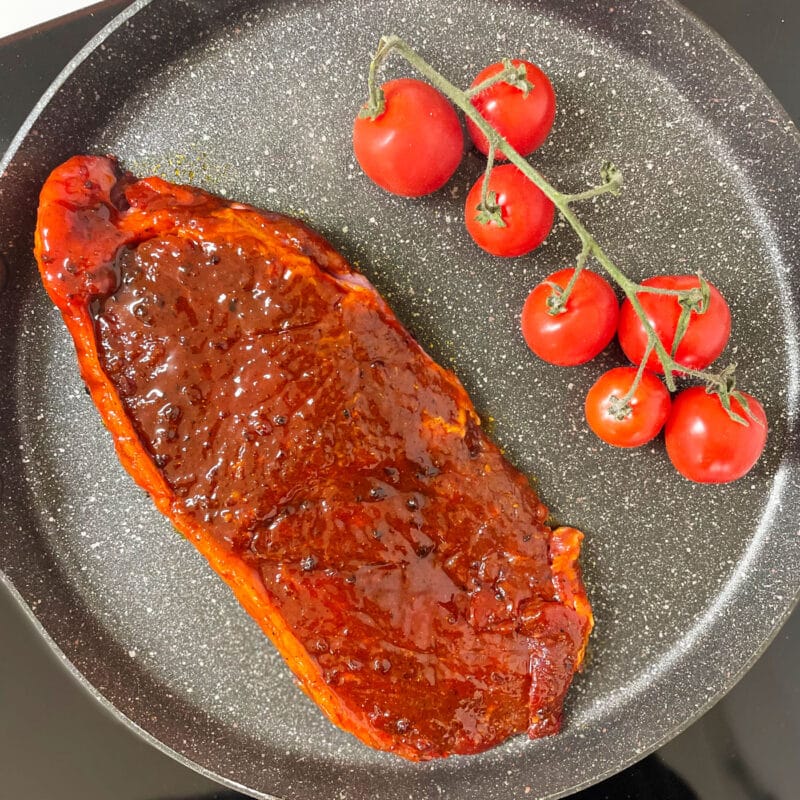 AVO Lafiness Whiskey and Black Pepper Butchers' Marinade on Raw Steak